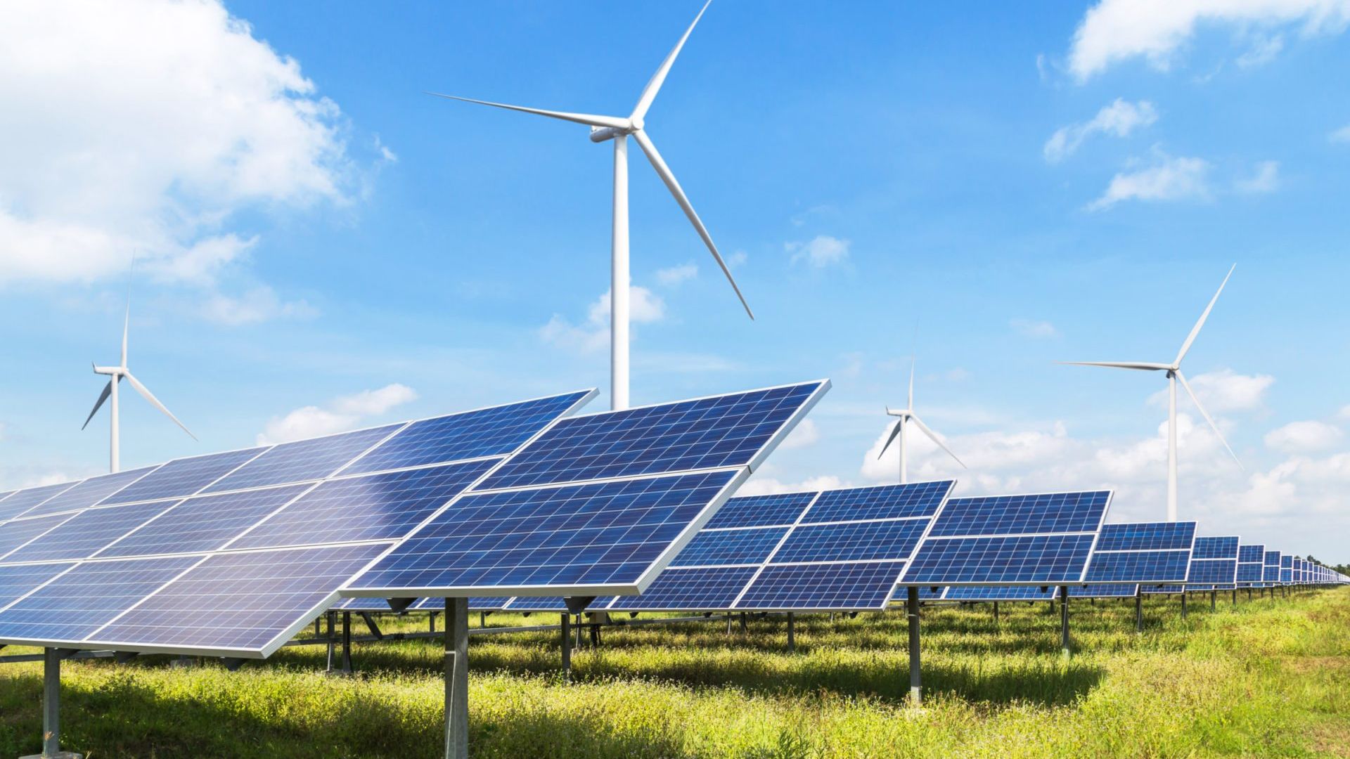 solar cells with wind turbines generating electricity in hybrid 1 AdobeStock 306677206 uai